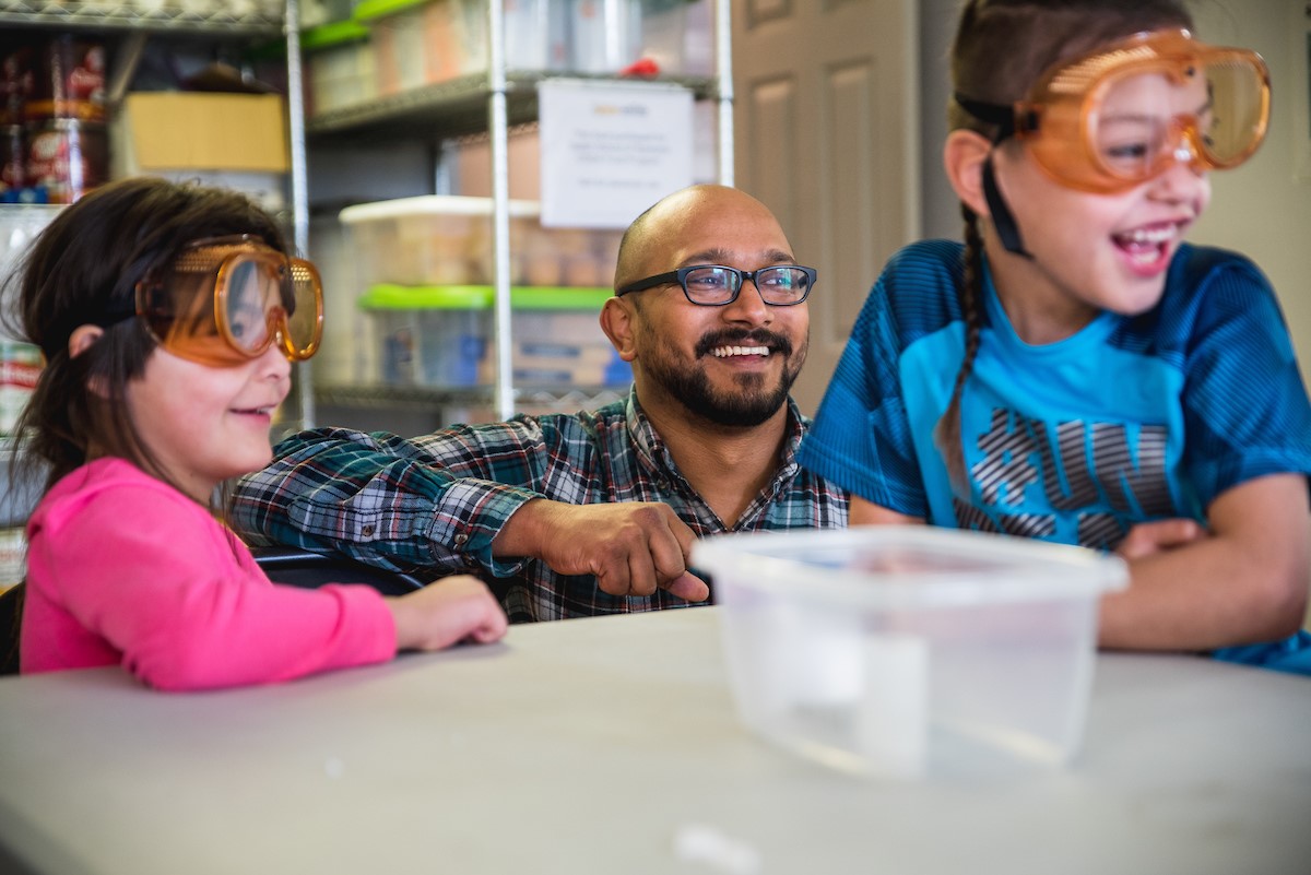 Rohan working with two students