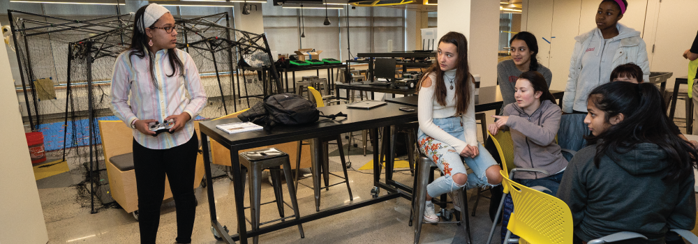 Students look on during science experiment 